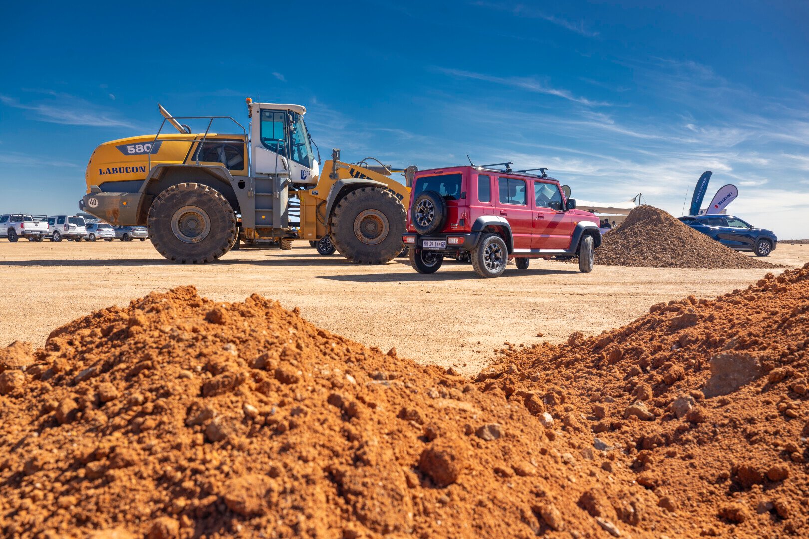 Red Jimny 5-Door and Tractor on the construction site