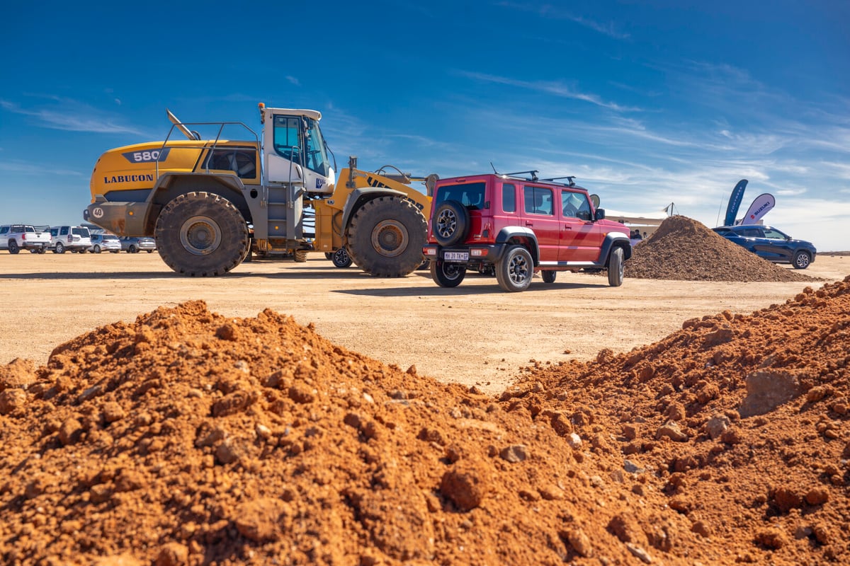 Red Jimny 5-Door and Tractor on the construction site