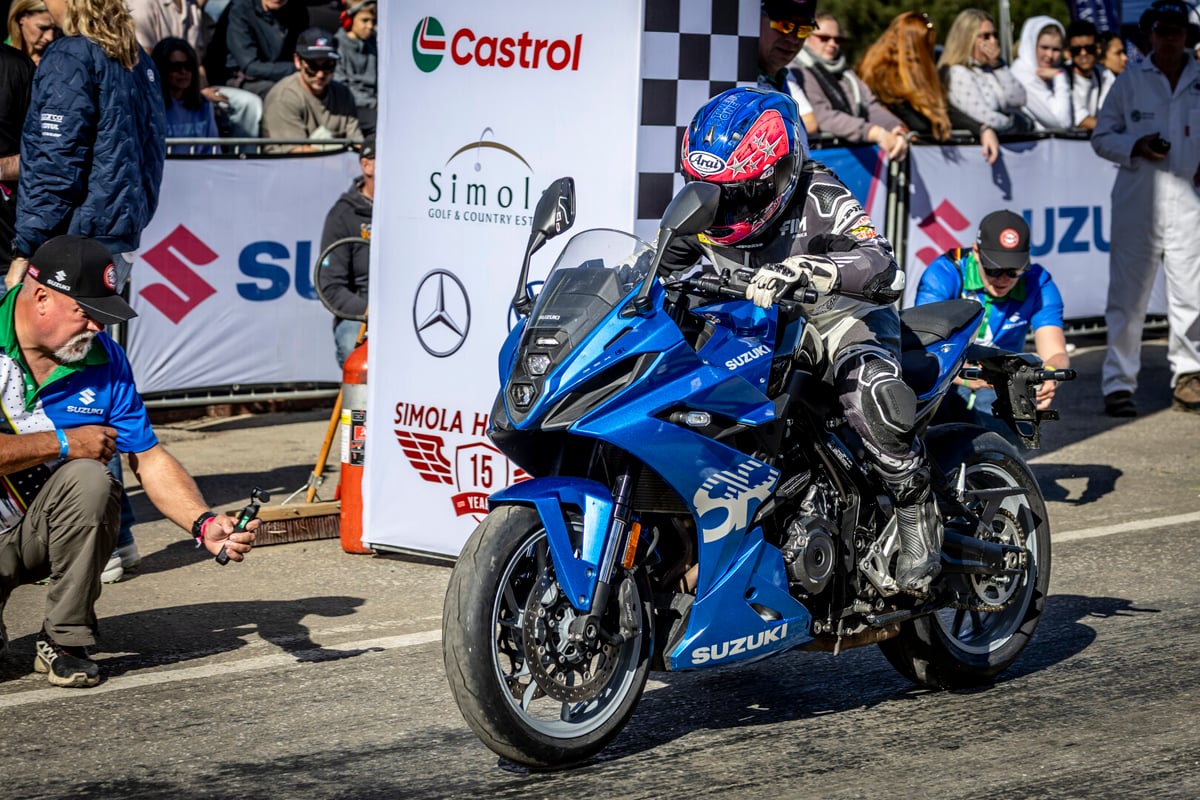 man on motorbike with suzuki logos in the background